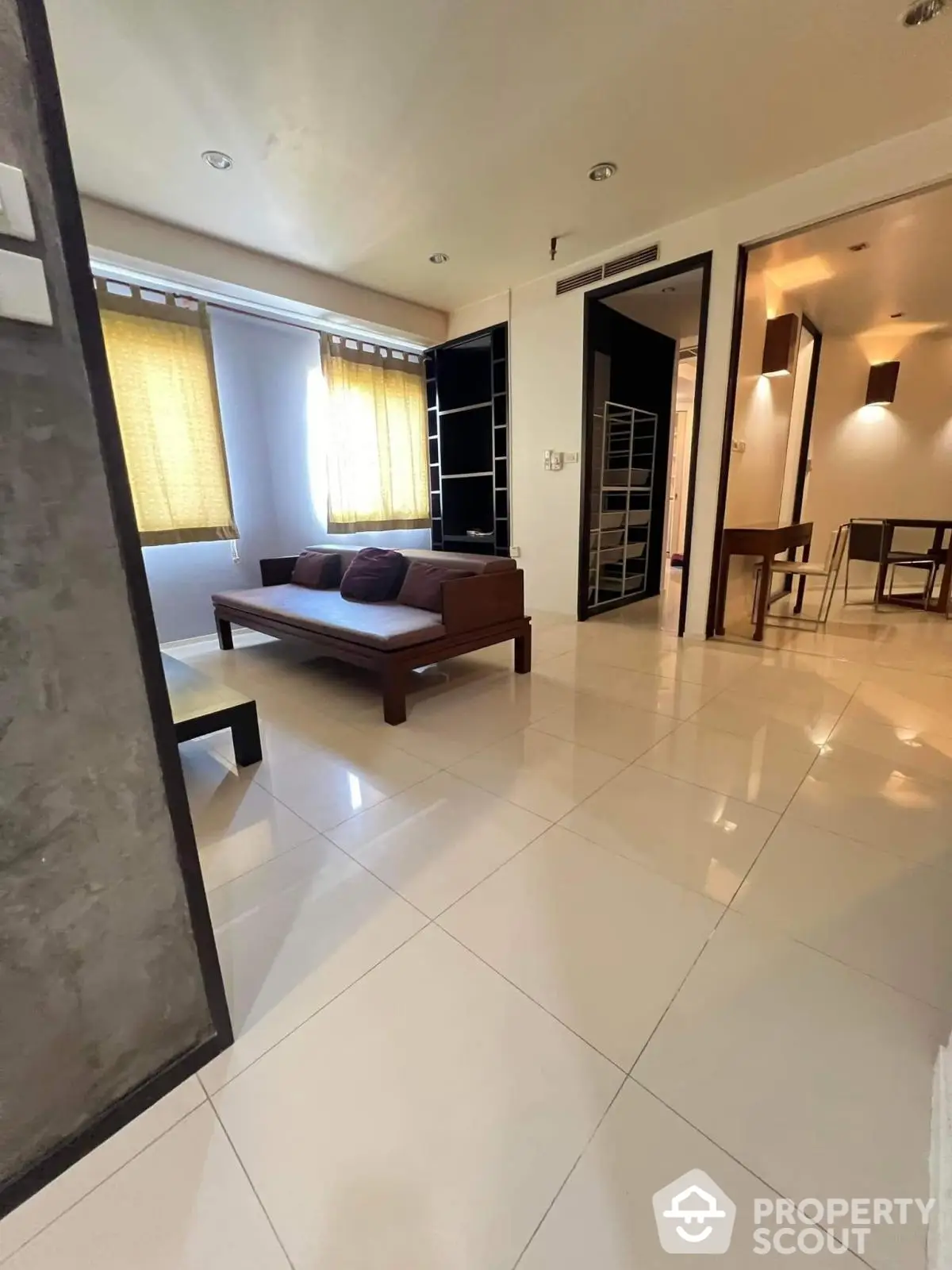 Modern living room with sleek furniture and natural light in a stylish apartment.