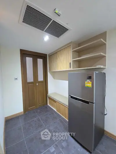 Modern kitchen with sleek fridge and ample storage space