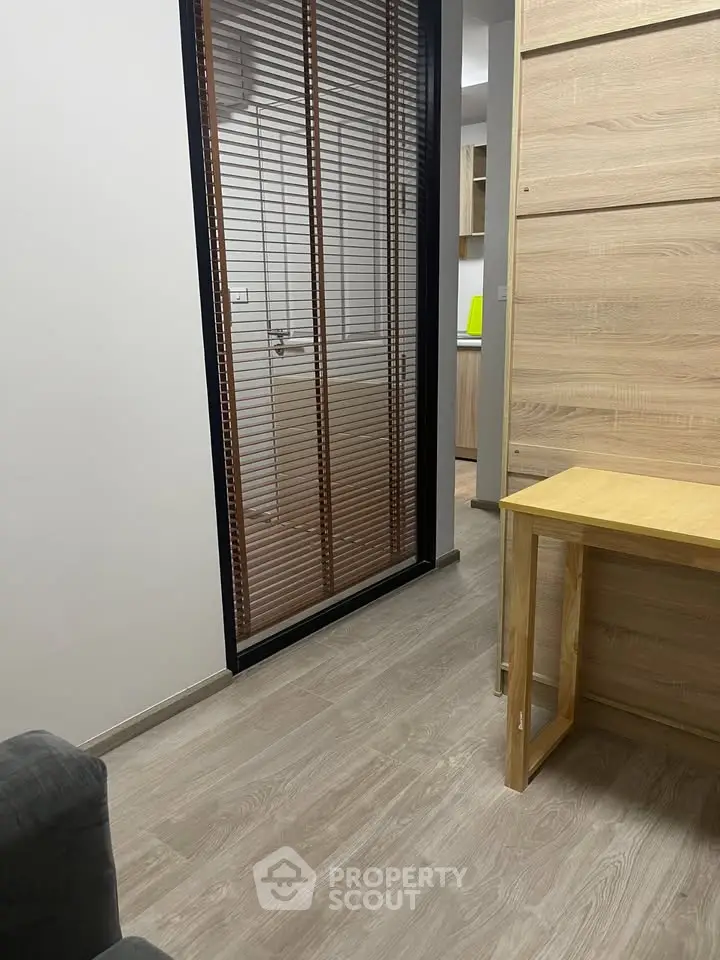 Modern interior with wooden flooring and stylish partition in cozy living space.