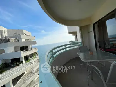 Stunning ocean view from a spacious balcony in a modern high-rise building.