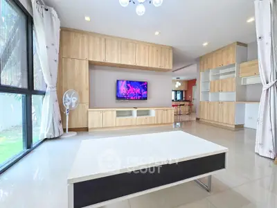 Spacious modern living room with built-in wooden cabinets and large windows