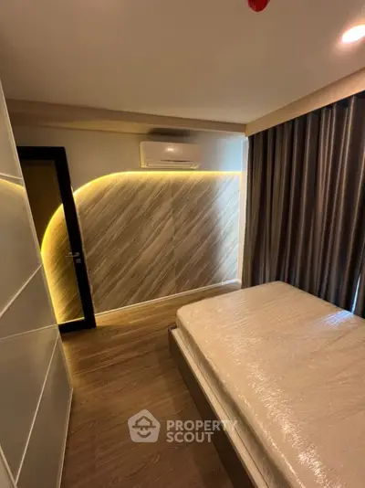 Modern bedroom with stylish lighting and floor-to-ceiling curtains