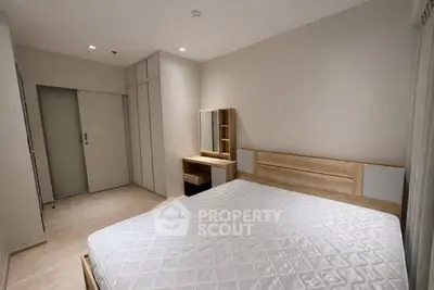 Spacious bedroom with modern wooden furniture and ample natural light
