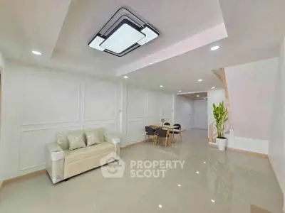 Spacious modern living room with sleek lighting and elegant dining area