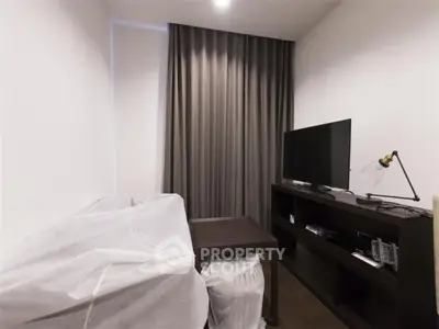 Cozy living room with modern TV setup and elegant curtains