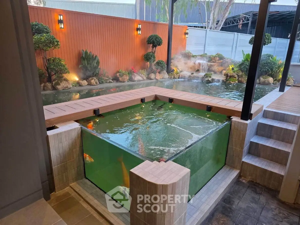 Luxurious backyard with koi pond and landscaped garden, perfect for relaxation and outdoor enjoyment.