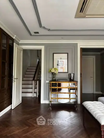 Elegant living room with herringbone wood flooring and stylish decor