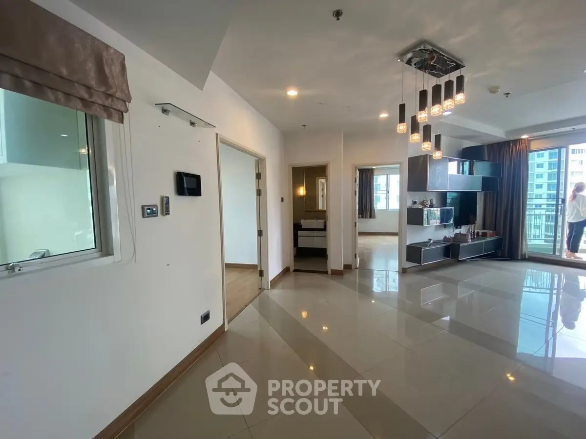 Spacious modern living room with balcony and elegant lighting