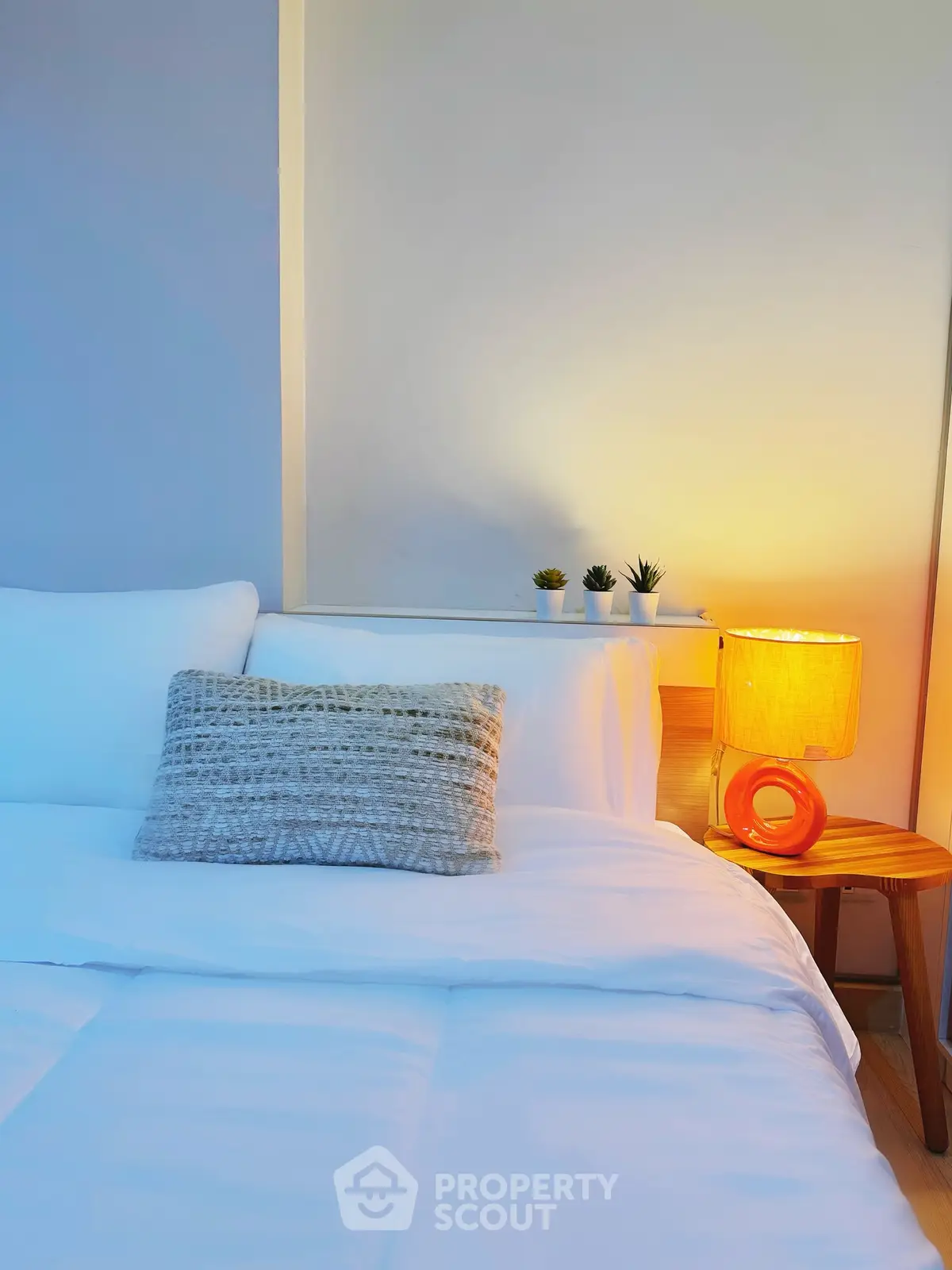 Cozy bedroom with stylish decor and warm lighting