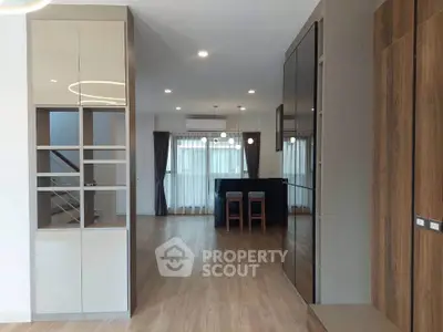 Spacious modern living room with elegant wooden flooring and stylish lighting