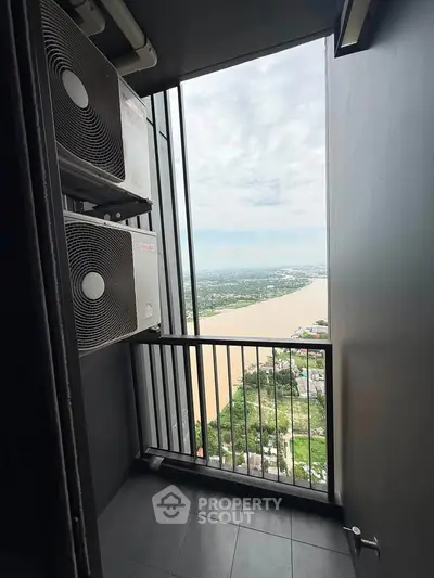 Stunning river view from a high-rise balcony with air conditioning units, perfect for urban living.