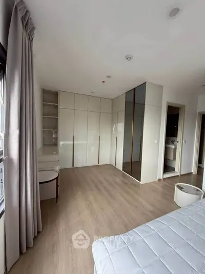 Spacious bedroom with modern wardrobe and natural light