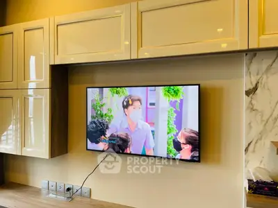 Modern living room with wall-mounted TV and sleek cabinetry