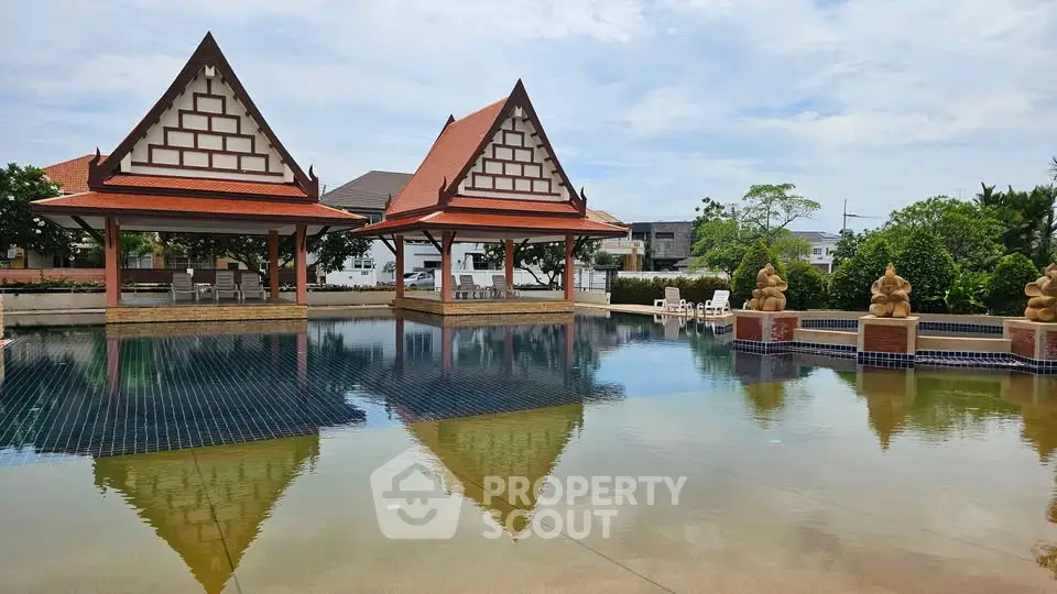 Stunning pool area with traditional architecture and serene surroundings, perfect for relaxation and leisure.