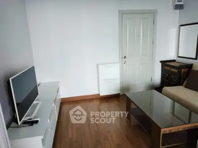 Cozy living room with modern TV setup and elegant wooden flooring