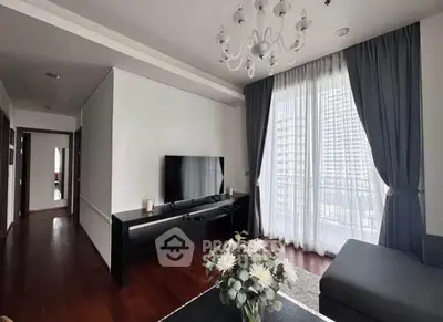 Modern living room with elegant chandelier and large window view
