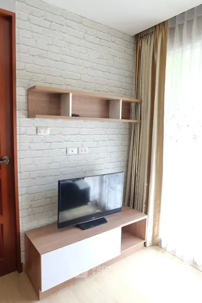 Modern living room with TV stand and brick accent wall