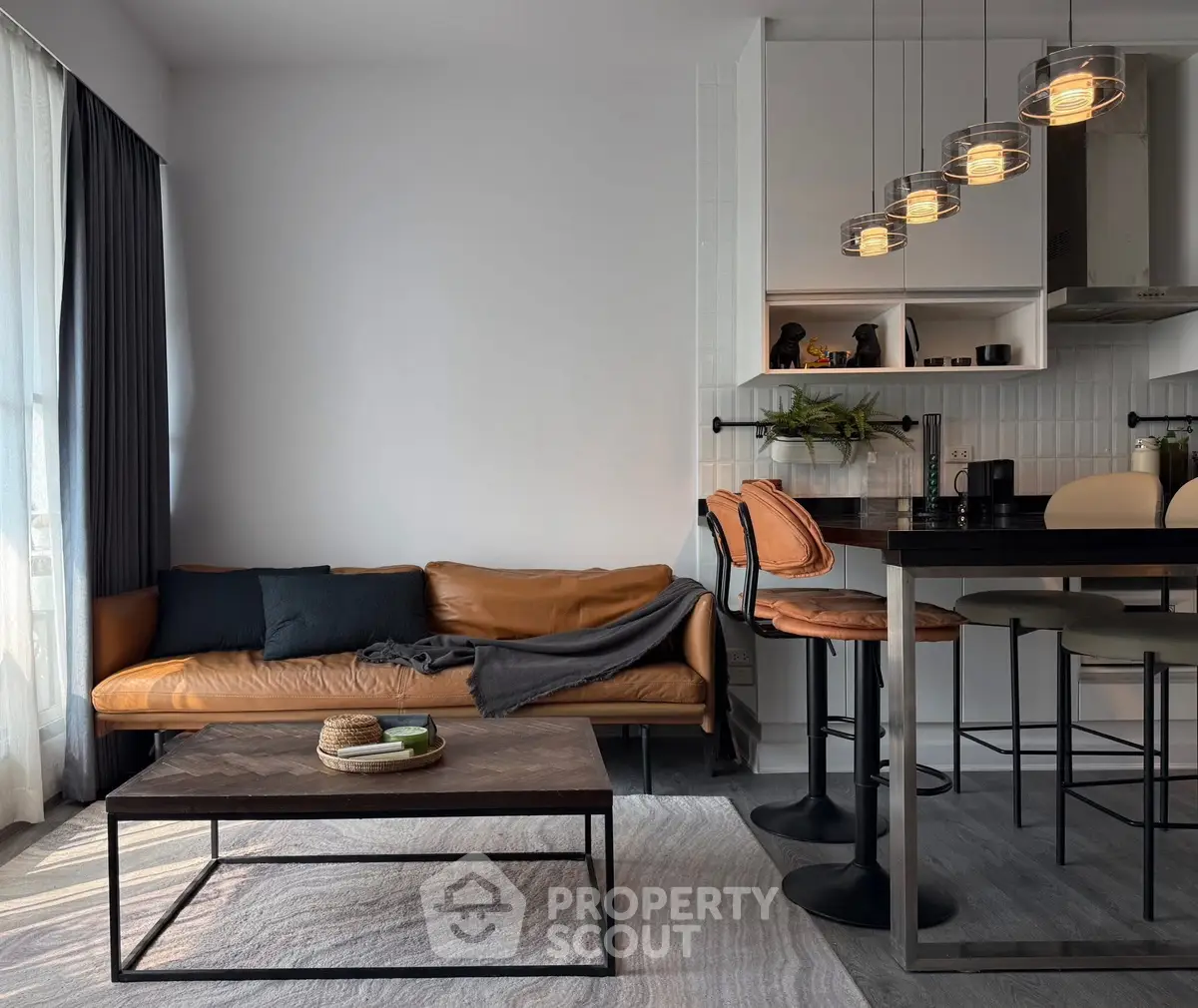 Modern living room with stylish leather sofa and chic bar stools