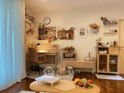 Charming living room with cozy decor and natural light, featuring a stylish workspace and wooden furniture.