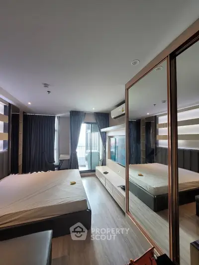 Modern bedroom with mirrored wardrobe and balcony view in stylish apartment