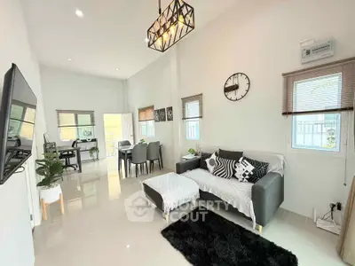 Modern living room with stylish decor, open layout, and abundant natural light
