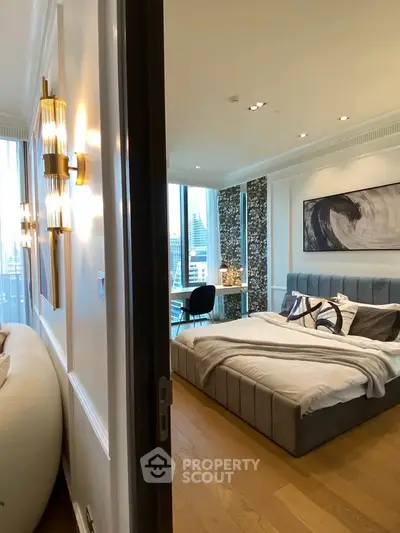 Luxurious bedroom with modern decor and city view, featuring elegant lighting and stylish furnishings.