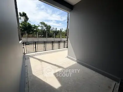 Spacious balcony with modern design and scenic view of lush greenery, perfect for relaxation and outdoor enjoyment.