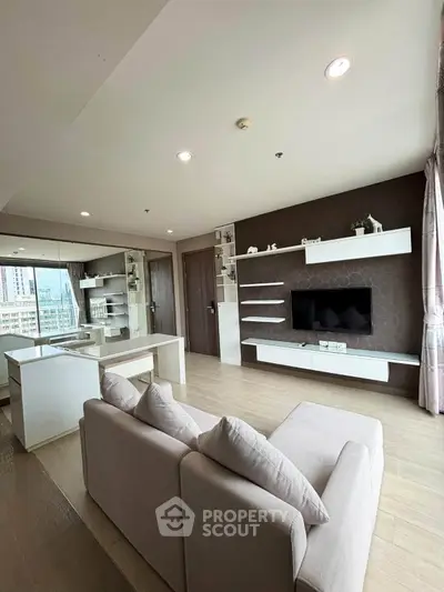 Modern living room with sleek design and large windows offering city views.