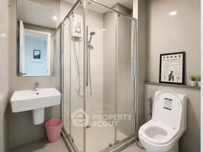 Modern bathroom with glass shower enclosure and sleek fixtures