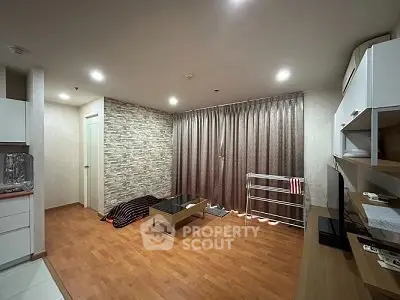 Modern living room with wooden flooring and stylish stone accent wall