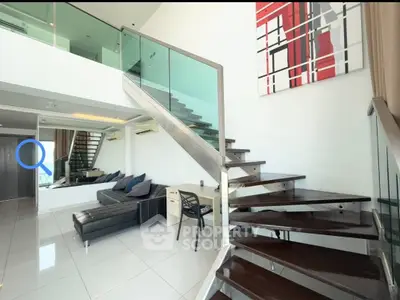 Modern duplex living room with stylish staircase and contemporary decor