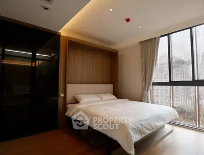 Modern bedroom with large window and stylish decor in luxury apartment