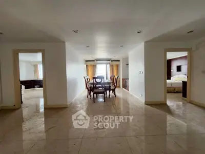 Spacious dining area with elegant furniture and natural light in a modern apartment.