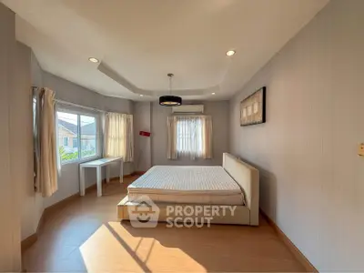 Spacious bedroom with large windows and modern decor