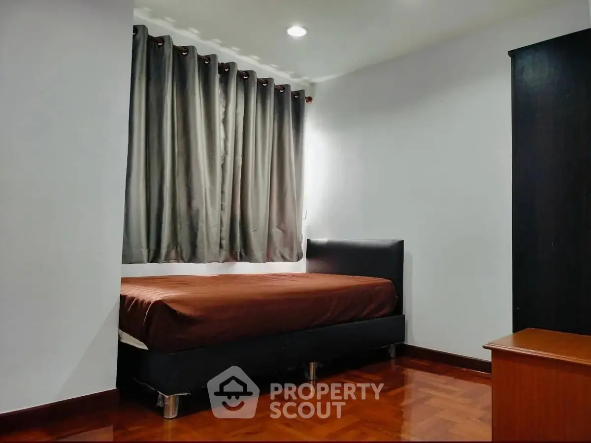 Cozy bedroom with modern decor and wooden flooring, perfect for relaxation.