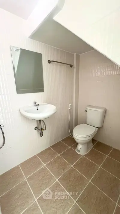 Modern bathroom with sleek fixtures and neutral tiles, perfect for a contemporary home.