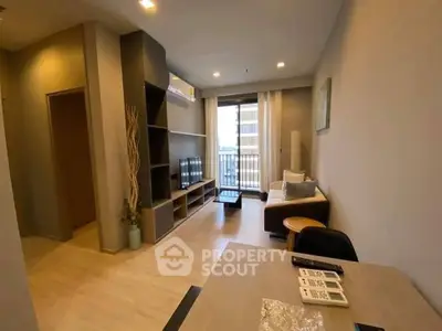 Modern living room with balcony access and stylish decor in a cozy apartment.