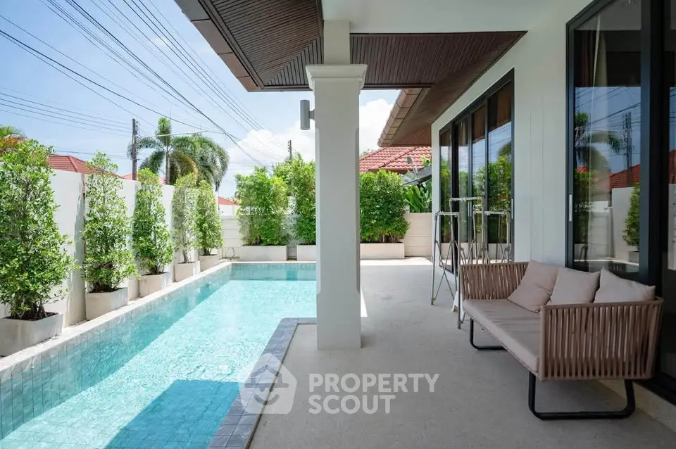 Luxurious villa with private pool and stylish outdoor seating area, perfect for relaxation.