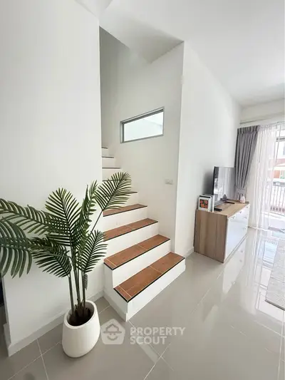 Modern interior with sleek staircase and stylish living area, perfect for contemporary living.