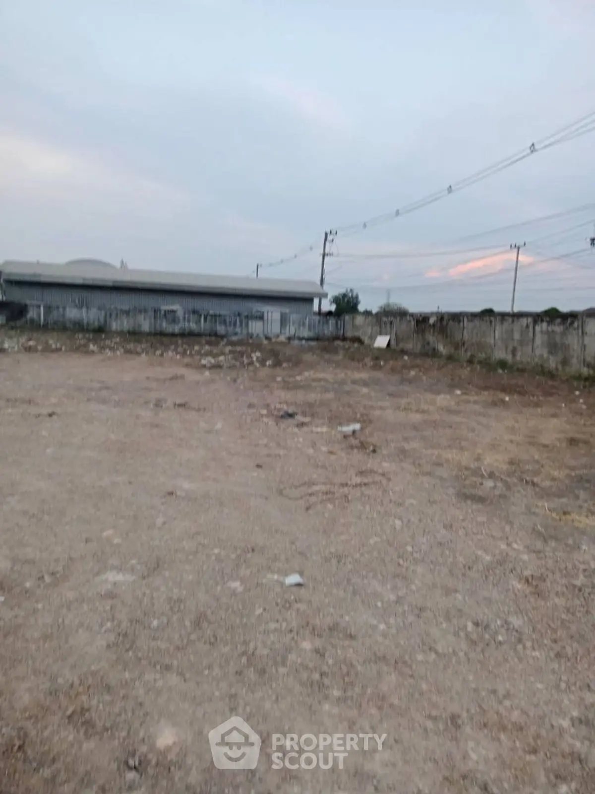 Expansive vacant land with potential for development, featuring open space and clear skies.
