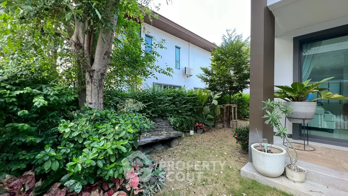 Charming garden view with lush greenery and modern exterior design