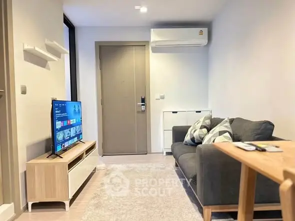 Modern living room with sleek furniture and wall-mounted TV, perfect for cozy relaxation.