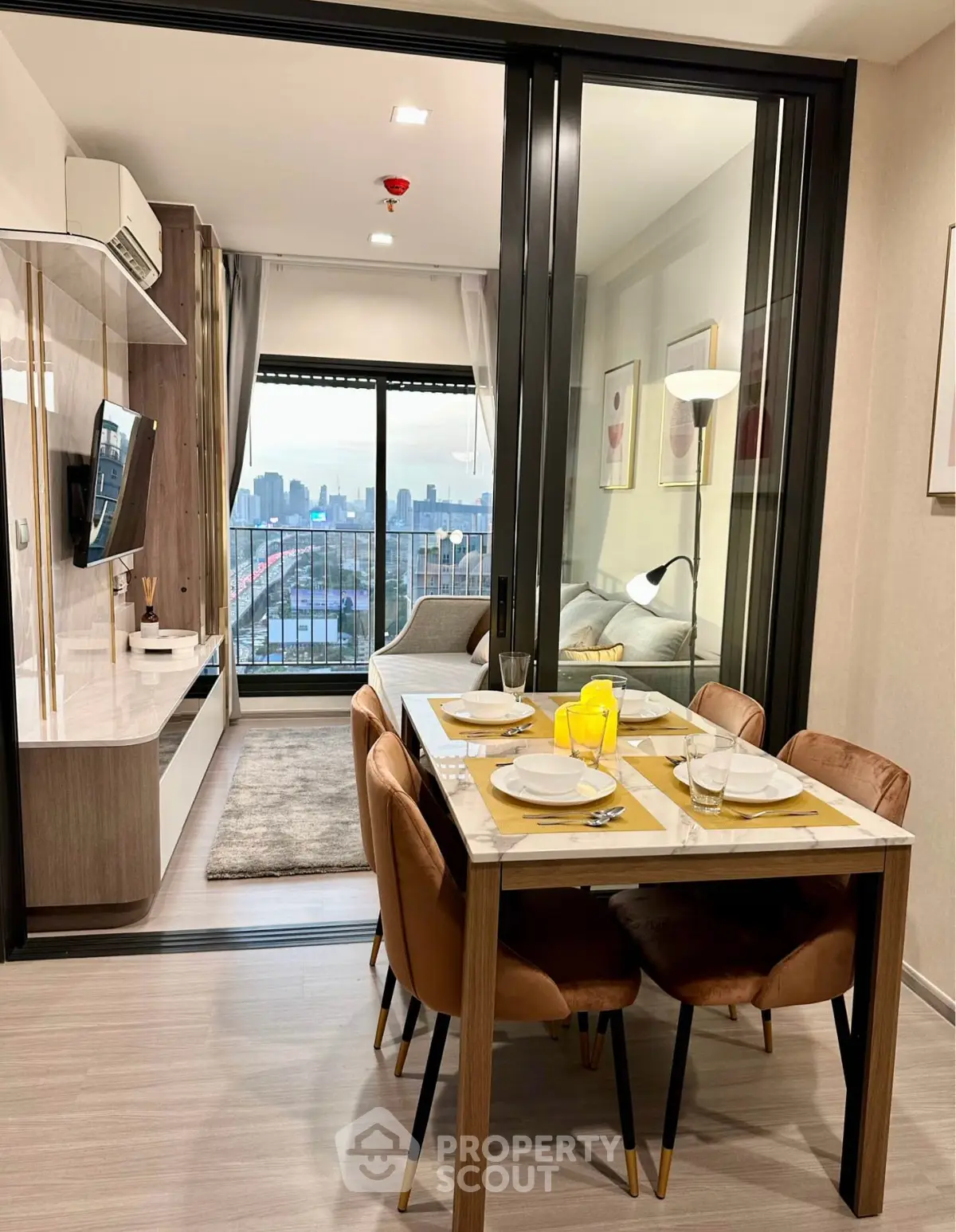 Modern apartment with open layout, stylish dining area, and city view balcony.