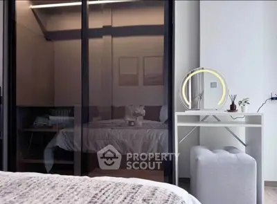 Modern bedroom with stylish decor and sleek glass wardrobe
