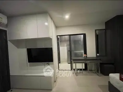 Modern living room with sleek design and built-in TV unit, perfect for urban living.