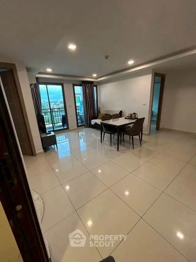 Spacious modern living room with balcony view in urban apartment