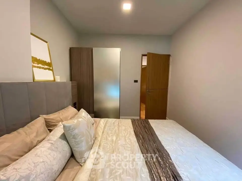 Cozy bedroom with modern decor and ample natural light