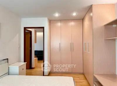 Spacious bedroom with built-in wardrobe and modern lighting