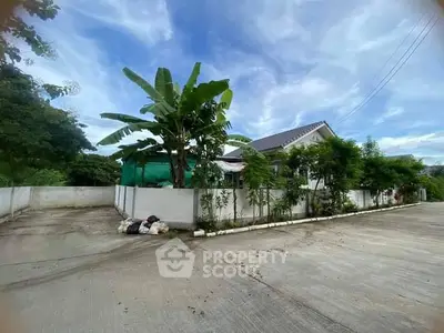 Charming suburban house with lush greenery and spacious driveway