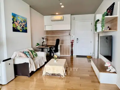 Modern living room with wooden flooring and stylish decor in a cozy apartment.